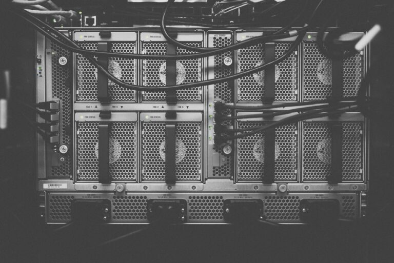 Black and white close-up of fans and cables on the back of a server